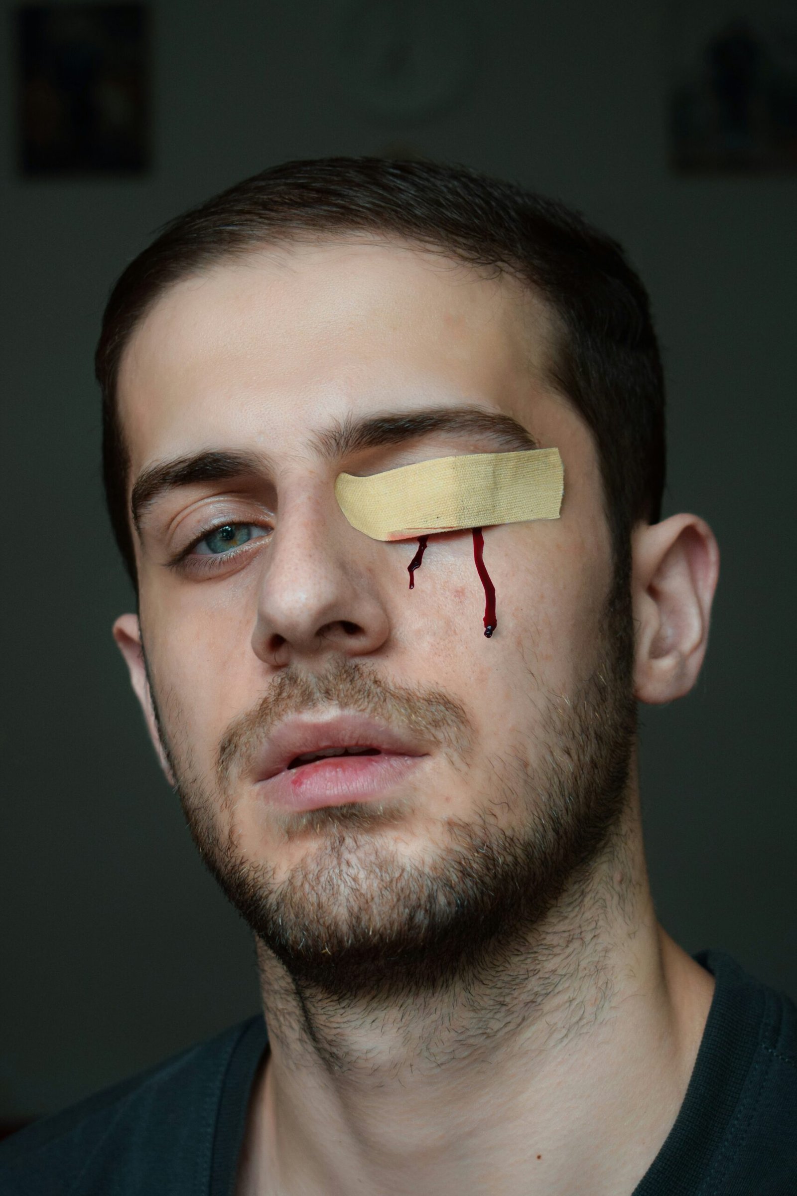 man with brown band aid on his mouth